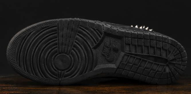 Blackened outsole with hand-scored cross hatching across the tread