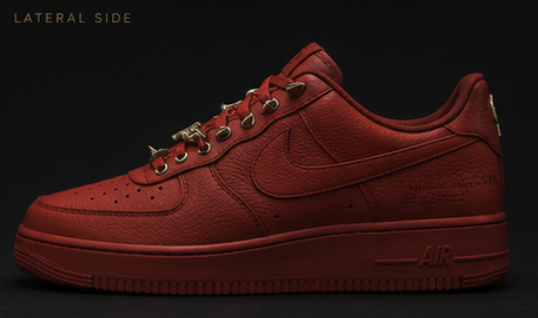 Lateral side profile of the red leather low-top with gold spike eyelets